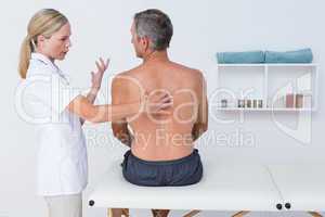 Doctor examining her patient back