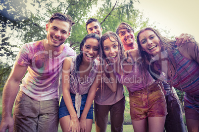 Happy friends covered in powder paint