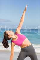 Fit woman doing fitness beside the sea