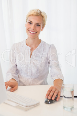 Portrait smiling blonde woman using computer