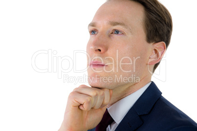 Thoughtful businessman looking away with hand on chin