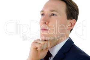 Thoughtful businessman looking away with hand on chin