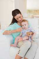 Happy mother eating with her baby boy