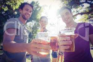 Happy friends in the park having beers