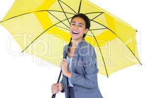 Smiling businesswoman sheltering under umbrella