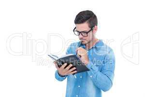 Geeky hipster holding book and pen