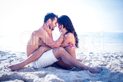 Happy cute couple hugging at the beach