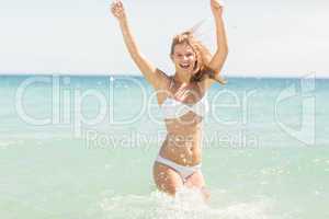 Happy pretty blonde cheering into the sea