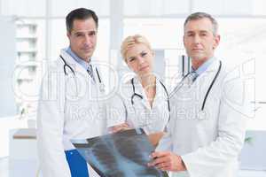 Concentrated doctors looking at camera