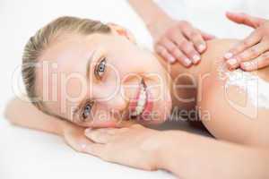 Beautiful woman receiving stone massage at spa center