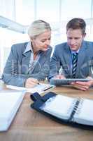 Business people using tablet in office