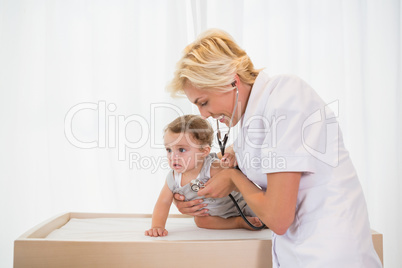 Blonde doctor with child and stethoscope
