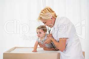 Blonde doctor with child and stethoscope