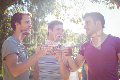 Happy friends in the park having beers