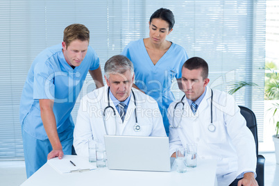 Team of doctors working on laptop