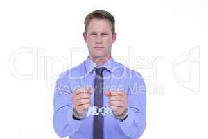 Handsome businessman wearing handcuffs