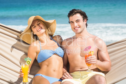 Happy couple relaxing on the hammock