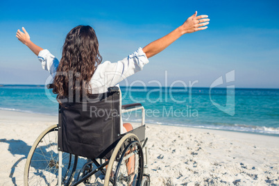 Disabled woman with arms outstretched at the beach