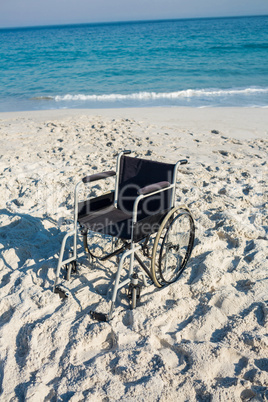 Black wheelchair on the beach