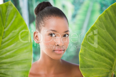 Pretty woman looking through leaves