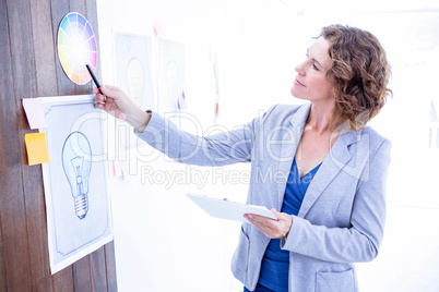 Creative businesswoman pointing color sample