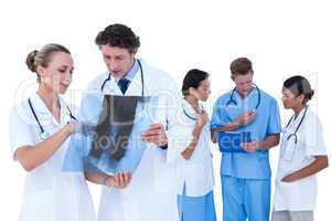 Doctors and nurses discussing over x-ray