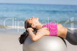 Fit woman stretching on exercise ball