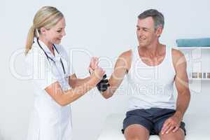 Doctor examining a man wrist