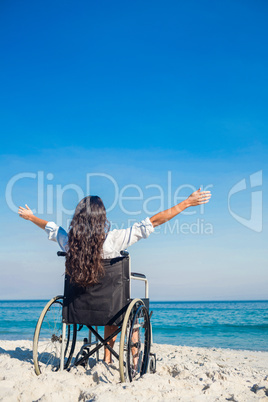 Disabled woman with arms outstretched at the beach