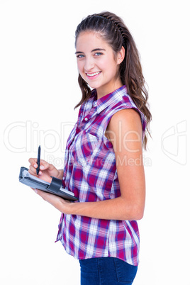 Pretty brunette writing on notebook