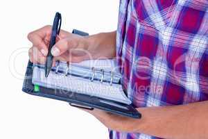 Close up view of woman writing on notebook