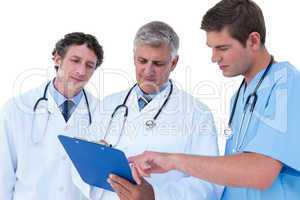 Doctors and nurse discussing over notes