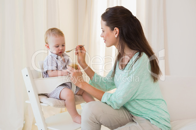 Happy mother eating with her baby boy
