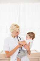 Smiling blonde doctor and child