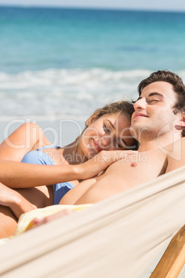 Happy couple napping together in the hammock