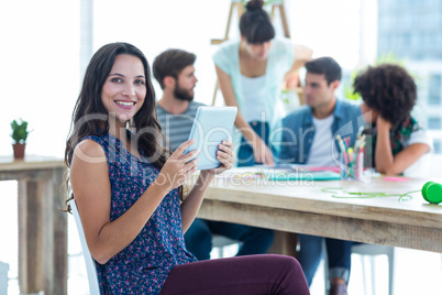 Smiling young women using digital tablet