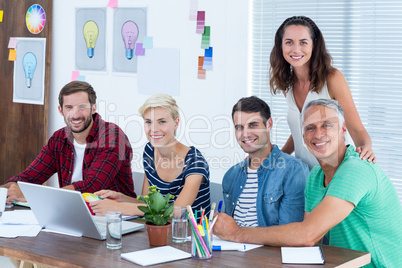 Creative business team using laptop in meeting