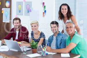 Creative business team using laptop in meeting