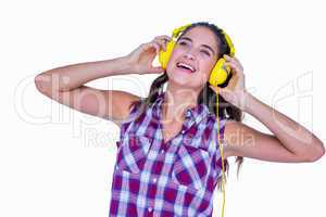 Pretty brunette listening music with headphone