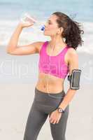 Pretty fit woman drinking water