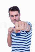 Handsome hipster attacking with his left fist
