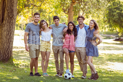 Happy friends in the park with football