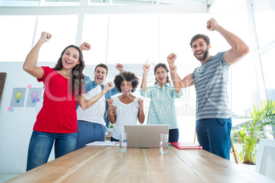 Happy business team with fists in the air