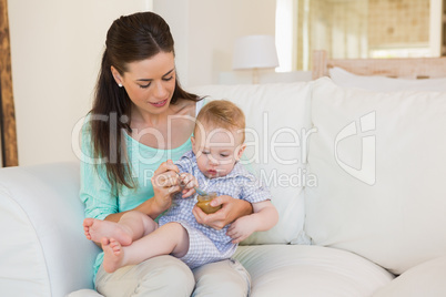 Happy mother eating with her baby boy