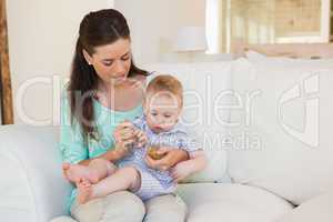 Happy mother eating with her baby boy