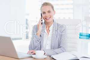 Smiling businesswoman using her computer