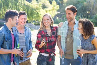 Happy friends in the park having barbecue