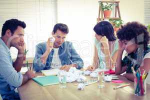 Exhausted business team making paper pellet