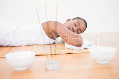 Peaceful pretty woman lying a bamboo mat