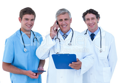 Doctor on the phone holding a clipboard